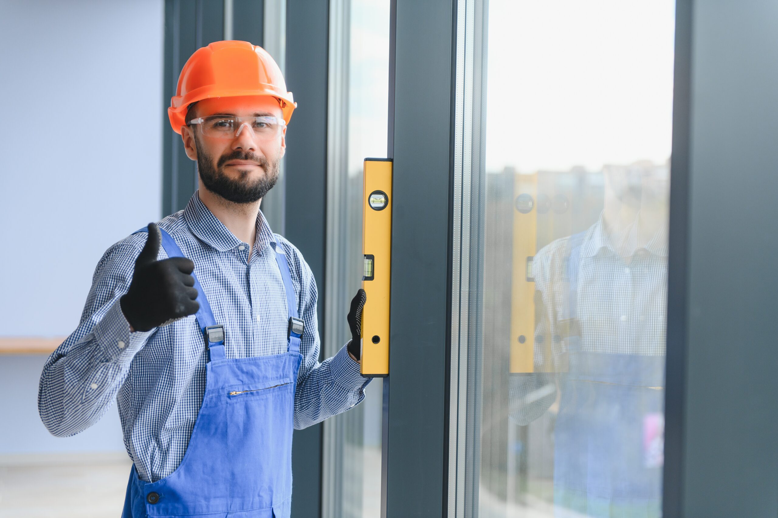 the foreman installs a window frame in the room